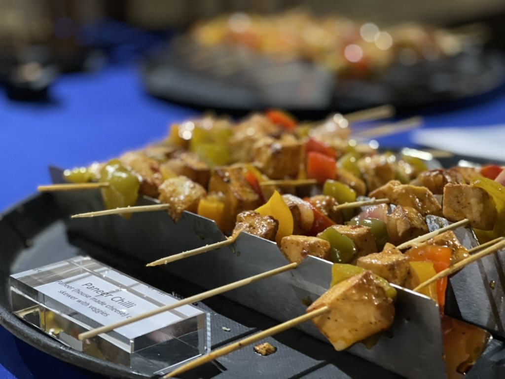 Paneer chilli skewers with peppers plated on slate at a Honest event